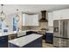 Beautiful kitchen featuring white and blue cabinets, a farmhouse sink, and a modern stainless steel refrigerator at 32525 Buchanan Ln, Albemarle, NC 28001