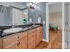 Well-lit bathroom featuring granite countertops, a dual sink vanity and access to the Primary bedroom at 338 Fairfield Ct, Mount Gilead, NC 27306