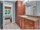 This bathroom has tile floors, granite vanity with wooden cabinets and access to the primary bedroom at 338 Fairfield Ct, Mount Gilead, NC 27306
