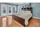 Bedroom with hardwood floors, large windows, and a comfortable bed at 338 Fairfield Ct, Mount Gilead, NC 27306