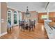 Formal dining room with wood table, elegant chandelier, and large windows at 338 Fairfield Ct, Mount Gilead, NC 27306