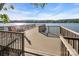 A lakeside dock offers an ideal spot for relaxation with a beautiful view of the calm water and horizon at 338 Fairfield Ct, Mount Gilead, NC 27306