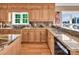 Well-appointed kitchen featuring wood cabinetry, granite countertops, and modern appliances at 338 Fairfield Ct, Mount Gilead, NC 27306