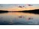 Picturesque lake scene reflecting a vibrant sunset with soft clouds and calm waters at 338 Fairfield Ct, Mount Gilead, NC 27306