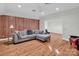 Spacious living room featuring wood paneling, hardwood floors, and comfortable seating at 338 Fairfield Ct, Mount Gilead, NC 27306