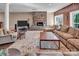 Spacious living room features a stone fireplace, wood paneling, and cozy seating around an area rug at 338 Fairfield Ct, Mount Gilead, NC 27306