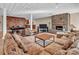 The inviting living room includes a stone fireplace, comfortable seating, a billiards table, and a bar at 338 Fairfield Ct, Mount Gilead, NC 27306