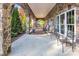 Covered patio with stone arches, chairs, and a view of the yard and trees at 338 Fairfield Ct, Mount Gilead, NC 27306