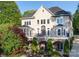 Stunning rear view of the home with a stone facade, large windows, and a spacious balcony overlooking landscaped gardens at 338 Fairfield Ct, Mount Gilead, NC 27306