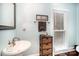 Quaint bathroom with stylish fixtures, vanity, and wood-look tile flooring at 3409 Pondview Ln, Charlotte, NC 28210