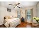 Cozy bedroom with hardwood floors, two windows, and neutral decor for a relaxing atmosphere at 3409 Pondview Ln, Charlotte, NC 28210