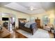 Comfortable bedroom with a ceiling fan, natural light, and a view into the ensuite bathroom at 3409 Pondview Ln, Charlotte, NC 28210