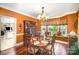Elegant dining room with hardwood floors, decorative chandelier, and a built-in china cabinet at 3409 Pondview Ln, Charlotte, NC 28210