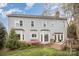 Rear exterior view of home showcases large windows, a well-maintained lawn, landscaping and charming deck access at 3409 Pondview Ln, Charlotte, NC 28210