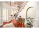 Stunning foyer with hardwood floors, a grand staircase, and views into the living room with fireplace at 3409 Pondview Ln, Charlotte, NC 28210