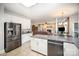 Modern kitchen featuring stainless steel refrigerator, granite countertops, and tile floors at 3409 Pondview Ln, Charlotte, NC 28210