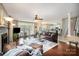 Expansive living room with hardwood floors, fireplace, and open layout connecting to a modern kitchen at 3409 Pondview Ln, Charlotte, NC 28210