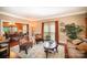 Well-lit living room features hardwood floors, neutral walls, and a seamless view into the adjacent dining area at 3409 Pondview Ln, Charlotte, NC 28210