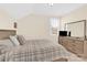 Bright bedroom featuring a window, soft carpet, a neutral color scheme, and a wooden dresser at 345 Somerled Way, Waxhaw, NC 28173
