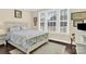 Bright bedroom with patterned bedding, hardwood floors, and large windows at 345 Somerled Way, Waxhaw, NC 28173
