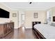 Bedroom featuring dark wood dresser, hardwood floors, and a large window at 345 Somerled Way, Waxhaw, NC 28173