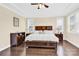 Spacious bedroom with a dark wood bed frame, hardwood floors, and two side tables at 345 Somerled Way, Waxhaw, NC 28173