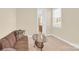 Bright bonus room featuring neutral carpet, a glass coffee table, and a comfortable couch at 345 Somerled Way, Waxhaw, NC 28173