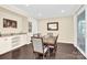 Dining room featuring a wooden table, six chairs, and a built-in bar with granite countertop at 345 Somerled Way, Waxhaw, NC 28173