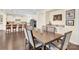 Dining room with wooden table, six chairs, built-in granite bar, and hardwood floors at 345 Somerled Way, Waxhaw, NC 28173