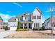 Beautiful two-story home with a well-manicured lawn and attached two-car garage on a sunny day at 345 Somerled Way, Waxhaw, NC 28173