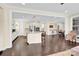 Open-concept living room featuring hardwood floors, neutral paint, and recessed lighting at 345 Somerled Way, Waxhaw, NC 28173