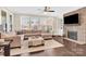 Spacious living room featuring a stone fireplace, hardwood floors, and ample natural light at 345 Somerled Way, Waxhaw, NC 28173