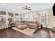 Cozy living room with large windows, hardwood floors, and comfortable seating area at 345 Somerled Way, Waxhaw, NC 28173