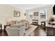 Comfortable living room with hardwood floors, bright windows, neutral furniture, and tasteful decor at 345 Somerled Way, Waxhaw, NC 28173