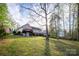 Large backyard with a deck, mature trees, and a grassy lawn at 3704 25Th Street Ne Pl, Hickory, NC 28601