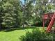 Expansive backyard featuring lush greenery and a charming deck, perfect for outdoor enjoyment at 3704 25Th Street Ne Pl, Hickory, NC 28601