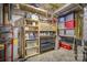 Unfinished basement featuring shelving with totes, tools, and a hot water heater at 3704 25Th Street Ne Pl, Hickory, NC 28601