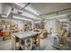 Spacious basement workshop featuring ample lighting and numerous work tables at 3704 25Th Street Ne Pl, Hickory, NC 28601