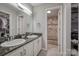 Bathroom with dual sinks, a separate shower, and built-in linen storage at 3704 25Th Street Ne Pl, Hickory, NC 28601