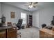 Carpeted bedroom features a ceiling fan, closet, a window, and two wooden desks at 3704 25Th Street Ne Pl, Hickory, NC 28601