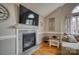 Living room fireplace with stone surround, a TV mounted above, and hardwood flooring at 3704 25Th Street Ne Pl, Hickory, NC 28601