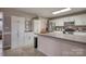 Well-lit kitchen features white cabinets, stainless steel appliances, and ample counter space at 3704 25Th Street Ne Pl, Hickory, NC 28601