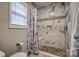 Stylish shower featuring marble-look tiles, pebble floor, and a rainfall showerhead at 3704 25Th Street Ne Pl, Hickory, NC 28601