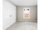 A well-lit bedroom featuring a double door closet and neutral carpeting at 416 E Park Ave, Gastonia, NC 28054