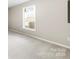 Bright bedroom with a window allowing natural light into the space and neutral color carpet at 416 E Park Ave, Gastonia, NC 28054