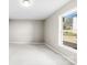 A clean and bright bedroom with a neutral color palette and a window providing natural light at 416 E Park Ave, Gastonia, NC 28054