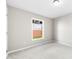 A bright, carpeted bedroom with a window view and neutral color scheme at 416 E Park Ave, Gastonia, NC 28054