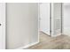 Hallway featuring modern wood-look floors and a door with a brushed metal handle at 416 E Park Ave, Gastonia, NC 28054