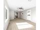 Open-concept living room with wood-look floors, ceiling fan and natural light at 416 E Park Ave, Gastonia, NC 28054
