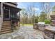Spacious backyard with stone patio, outdoor kitchen, stainless steel grill, and stairs to screened-in porch at 4231 Brushy Knl, York, SC 29745
